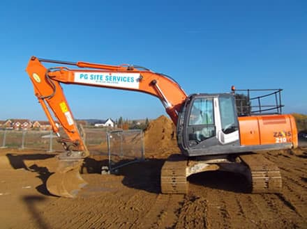 Side view of Digger working on housing estate