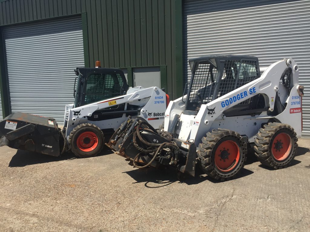 Two Skid-steer loaders - Side view